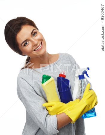 Beautiful cheerful brunette woman in gloves holding different cleaning stuff 9503467