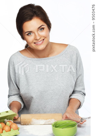 Young brunette woman with rolling pin preparing dough 9503476