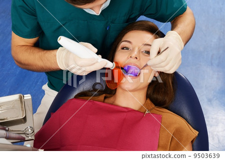 Young woman and man doctor at dentist's surgery 9503639
