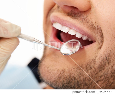Man doing teeth checkup at dentist's surgery 9503658
