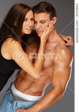 Young woman embracing man with naked muscular torso Young woman embracing man with naked muscular torso 9503663