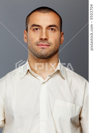 Handsome man in white shirt isolated on grey background 9503704