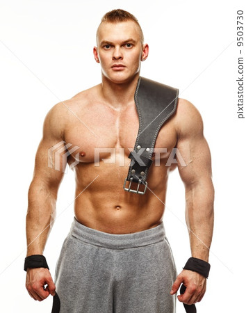 Muscular young sportsman with weight lifting belt Muscular young sportsman with weight lifting belt 9503730