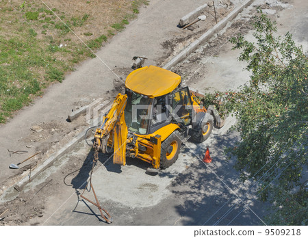 tractor performs road works to repair pavement tractor performs road works to repair pavement 9509218
