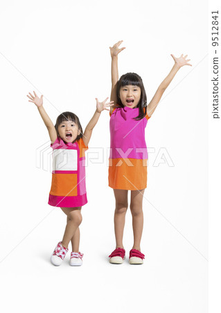 Sisters standing by raising both hands 9512841