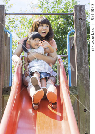 Parents and children playing on the slide 9513070