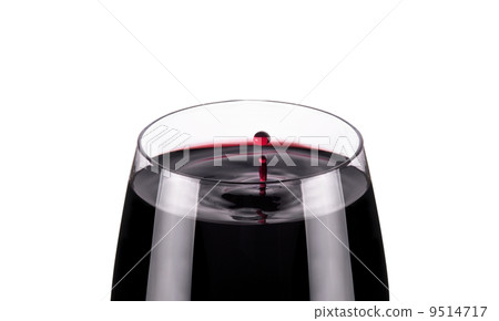 glass of red wine, drops in motion, studio shot 9514717