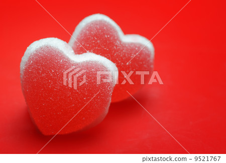 Sugar hearts on red background 9521767