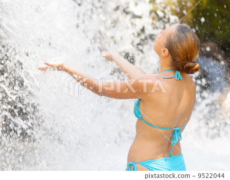 Young woman relaxing in waterfall Young woman relaxing in waterfall 9522044