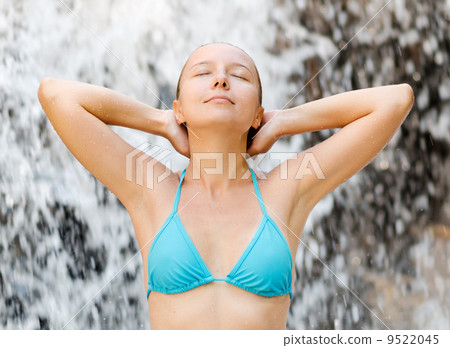 Young woman relaxing in waterfall Young woman relaxing in waterfall 9522045