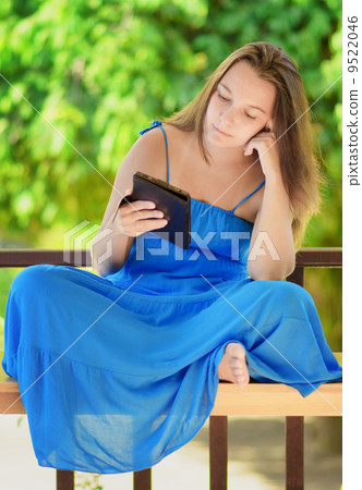 Young woman reading e-book. Outdoor portrait Young woman reading e-book. Outdoor portrait 9522046