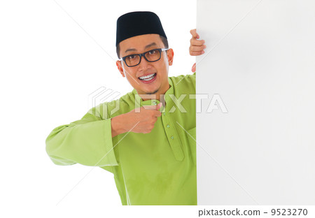 malay male with blank card during hari raya Eid al-Fitr aidilfit 9523270