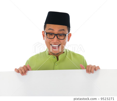 malay male with blank card during hari raya Eid al-Fitr celebrat 9523271