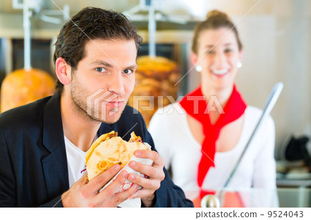 Kebab - customer and hot Doner with fresh ingredients 9524043