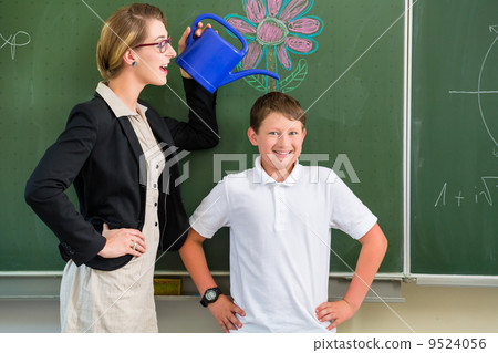 Teacher or docent motivate student or pupil or boy in front of a 9524056