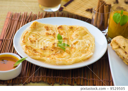 roti canai and teh tarik, very famous drink and food in malaysia roti canai and teh tarik, very famous drink and food in malaysia 9529505