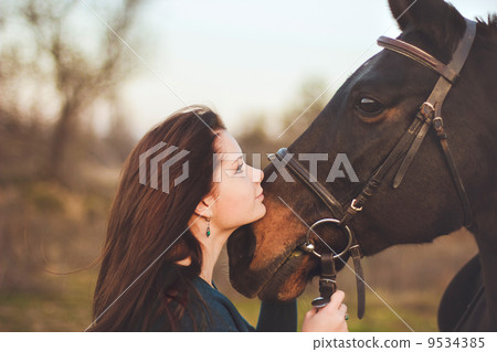 Young woman with a horse on nature Young woman with a horse on nature 9534385