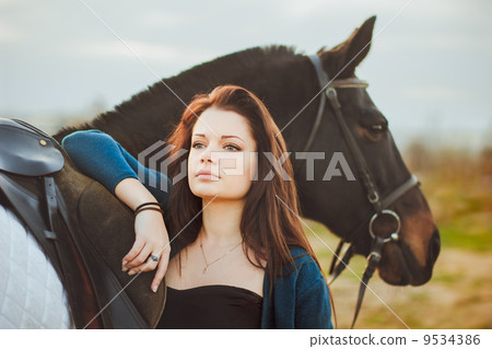 Young woman with a horse on nature Young woman with a horse on nature 9534386
