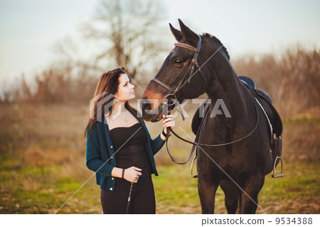 Young woman with a horse on nature Young woman with a horse on nature 9534388