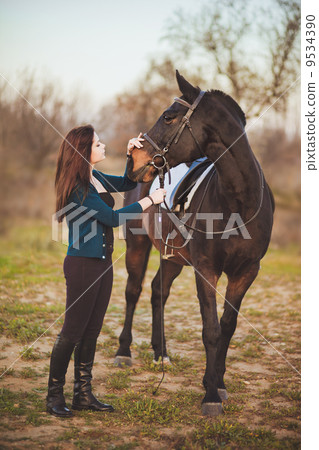 Young woman with a horse on nature Young woman with a horse on nature 9534390