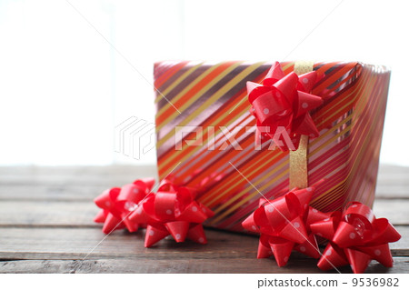 Gift wrapping supplies decorated with red ribbons Gift wrapping supplies decorated with red ribbons 9536982