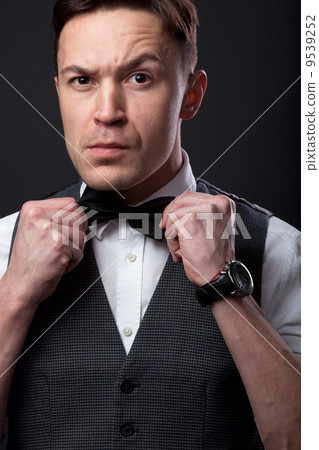 Young handsome man with bow tie 9539252