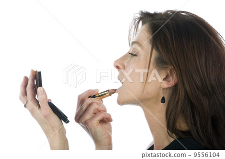 Pretty woman applying make up. Pretty woman applying make up. 9556104