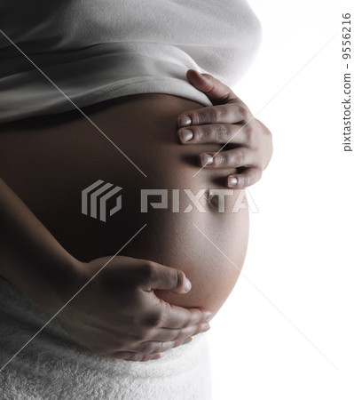 Image of pregnant woman touching her belly with hands Image of pregnant woman touching her belly with hands 9556216