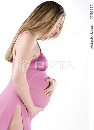 .Image of pregnant woman touching her belly with hands.. .Image of pregnant woman touching her belly with hands.. 9556315
