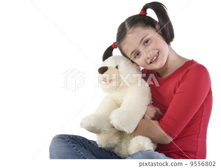 Little girl is hugging big teddy bear 9556802