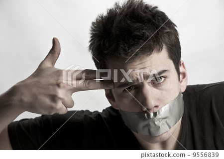 Man with mouth covered by masking tape preventing speech.. Man with mouth covered by masking tape preventing speech.. 9556839