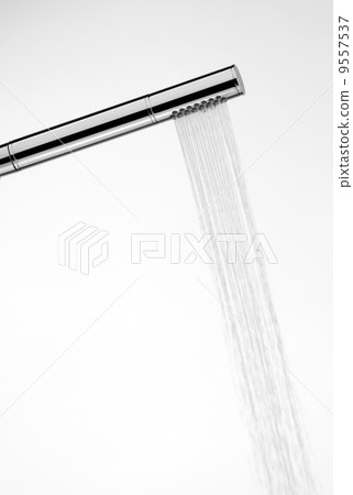 A shower head is spraying water. A shower head is spraying water. 9557537