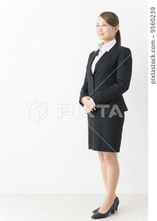 A woman in a suit in her half (whole body) 9560239