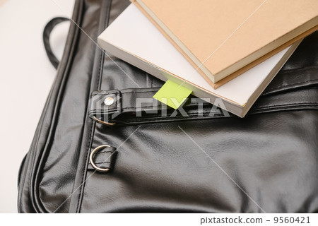 Books and notebooks placed in a black bag Books and notebooks placed in a black bag 9560421