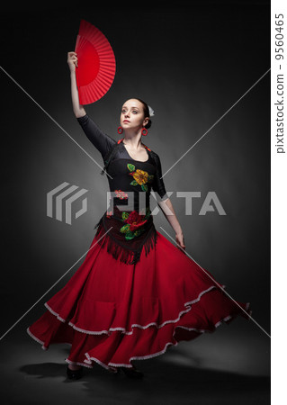 young woman dancing flamenco with fan on black 9560465