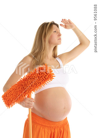 pregnant woman with a mop looks forward pregnant woman with a mop looks forward 9561088
