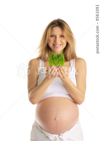 pregnant woman holding green grass pregnant woman holding green grass 9561091