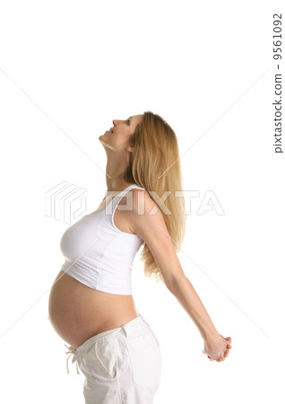 Pregnant woman practicing yoga 9561092