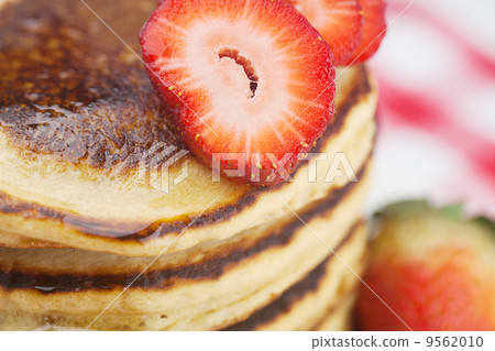 Pancakes, honey and strawberry on checkered fabric 9562010