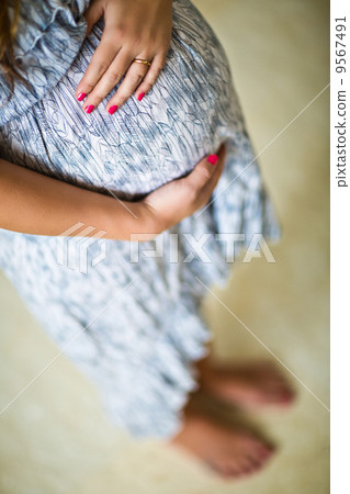 young pregnant pan-asian woman young pregnant pan-asian woman 9567491