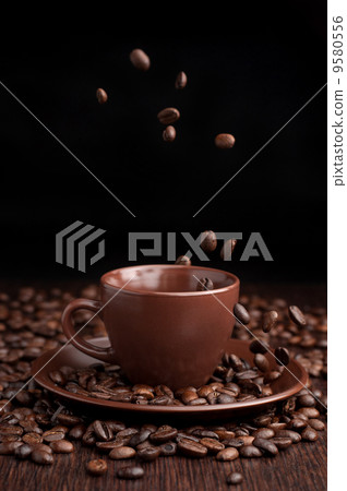 Coffee beans flow in a cup Coffee beans flow in a cup 9580556