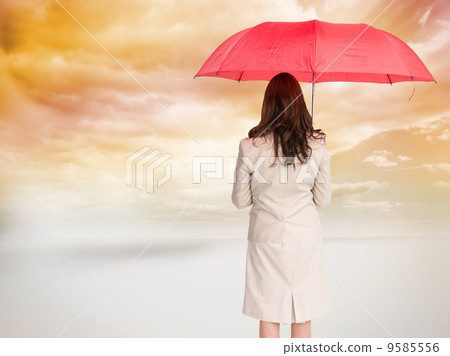 Composite image of businesswoman standing back to camera holding 9585556