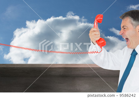 Composite image of businessman screaming directly into the hands Composite image of businessman screaming directly into the hands 9586242