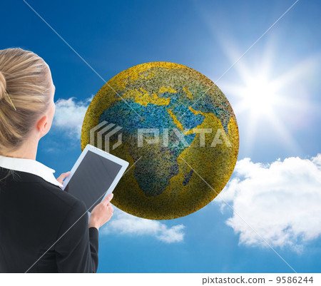 Composite image of businesswoman holding new tablet 9586244