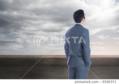 Composite image of businessman standing 9586351