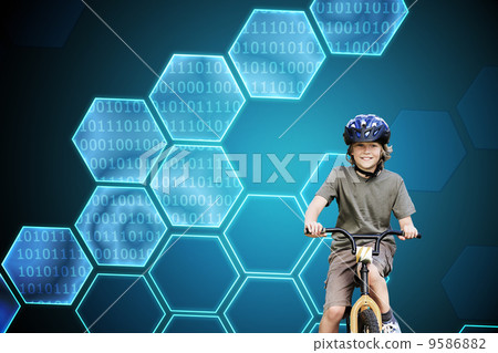 Composite image of little boy with his bike in a park 9586882