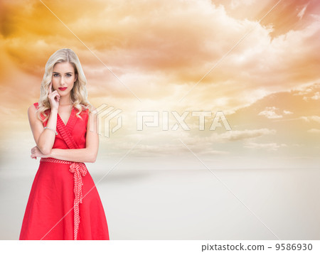 Composite image of thoughtful blonde wearing red dress Composite image of thoughtful blonde wearing red dress 9586930