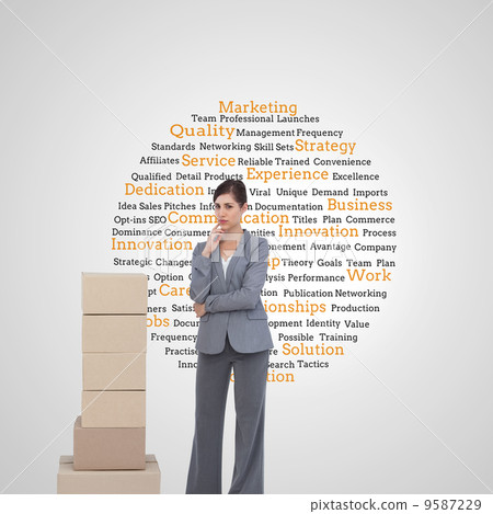 Composite image of thoughtful businesswoman posing with cardboar Composite image of thoughtful businesswoman posing with cardboar 9587229