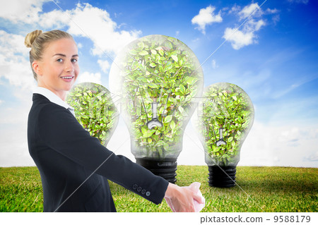 Composite image of businesswoman holding piggy bank Composite image of businesswoman holding piggy bank 9588179