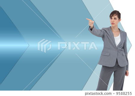 Composite image of young businesswoman pointing to something 9588255